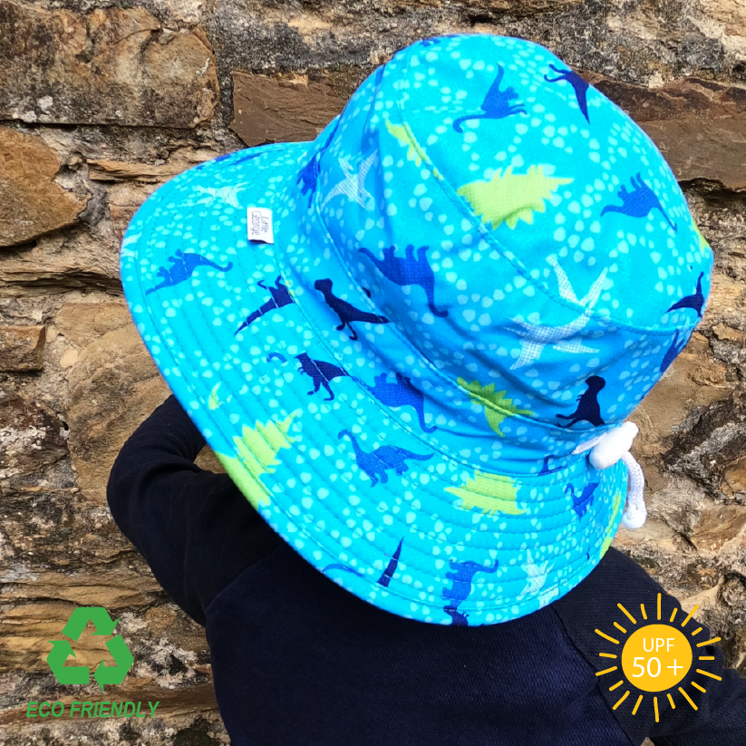 Eco-friendly kids bucket hat made from rPet fabric with vibrant dinosaur print, wide brim for all-day sun protection, and secure breakaway strap for active play.”