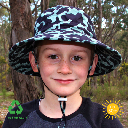 Children’s bucket sun hat in classic camouflage print, featuring wide brim, safety-release chin strap, and breathable recycled fabric.