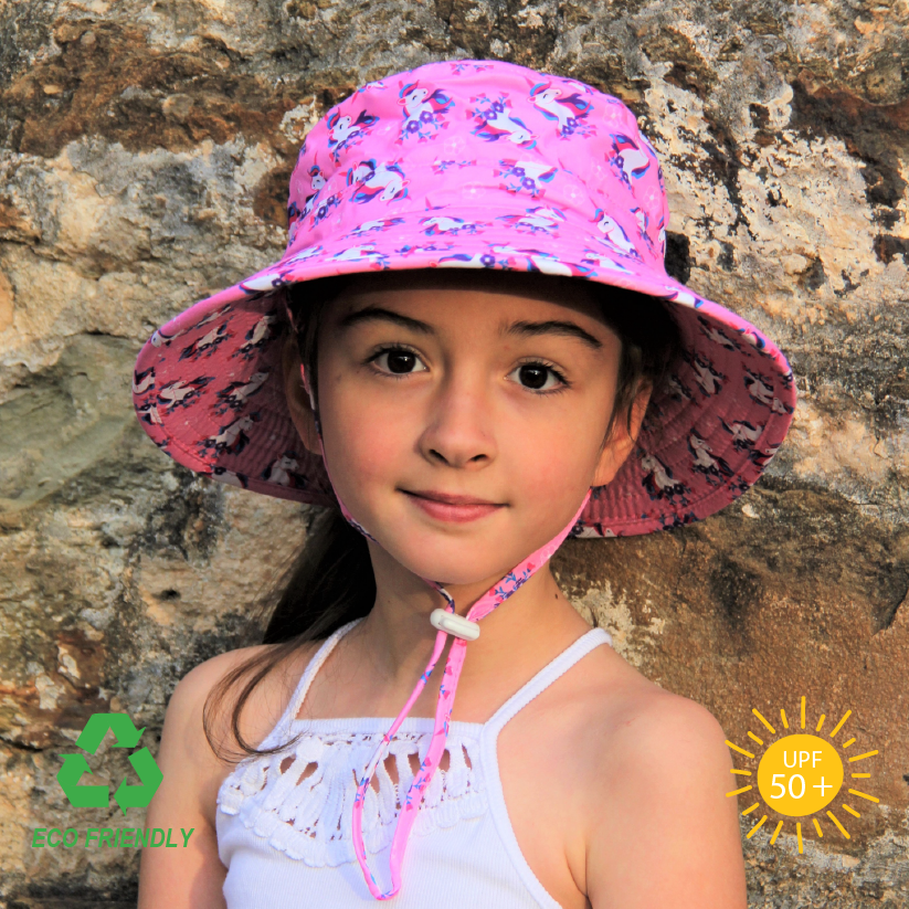 Kids bucket sun hat with whimsical unicorn print, wide anti-flop brim, breakaway chin strap, and soft recycled rPET fabric for magical sun-safe adventures