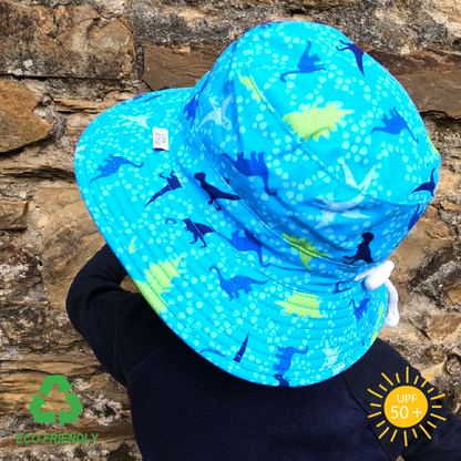 Kids sun hat with bold dinosaur print, wide brim for UV protection, breakaway chin strap, and eco-friendly recycled fabric for outdoor play