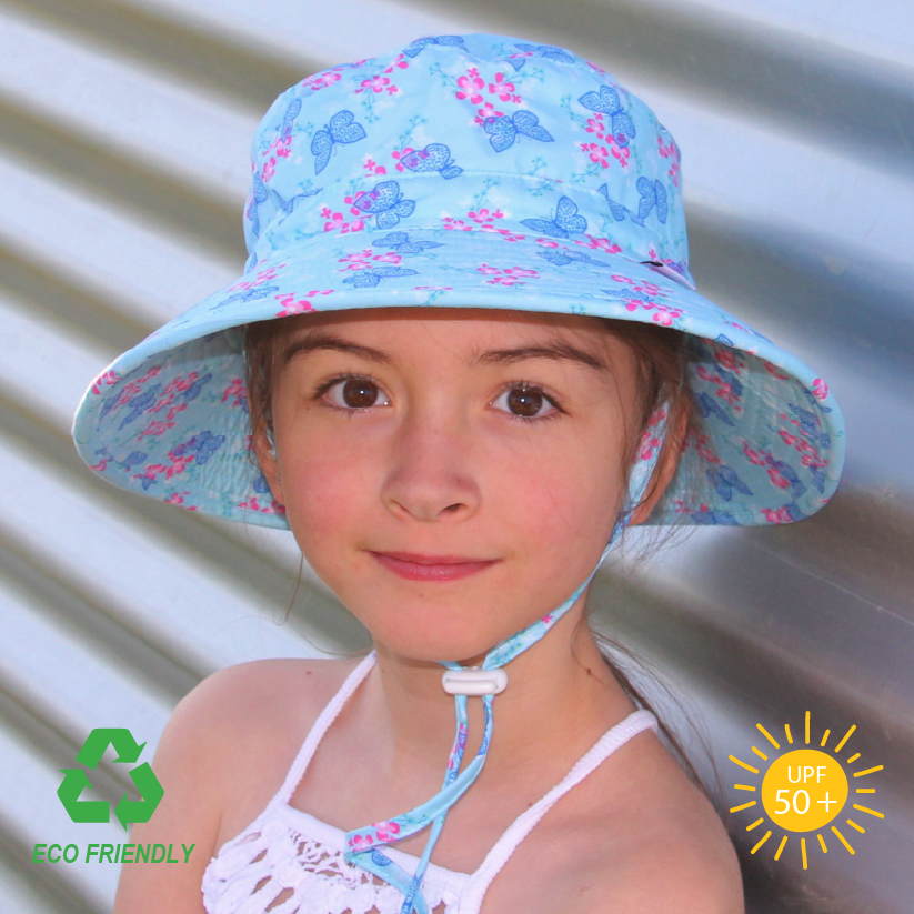 Kids bucket sun hat with whimsical butterfly garden print, wide anti-flop brim, safety-release chin strap, and breathable recycled rPET fabric.